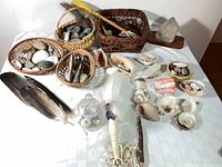 Overall lot: quartz crystal, wicker baskets, rocks, shells, feathers, glass globe