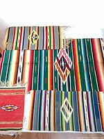 All four serapes laid out showing sizes and patterns