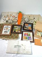 Overview of lot showing framed pieces, panels, carrot, Loomette set