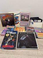 Overall view of boxed games, manuals, cartridge package and floppy disks