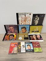 Front view of nine Elvis CDs and five cassette tapes