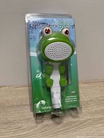 Front of sealed package showing frog handheld shower head