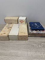 Overview of six card boxes and stack of binder pages with binder