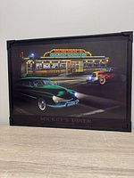 Front view of illuminated picture showing diner scene