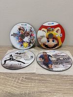 Front view of four Wii U game discs showing titles and graphics