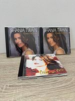 Front view of three Shania Twain Come On Over CDs