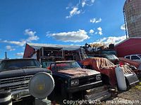 Full view of shelving rows behind parked vehicles inside open shed