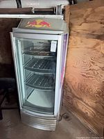 Full view of Red Bull glass-door fridge with interior shelves