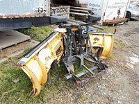 Full view of snow plow assembly resting on ground