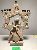 Full view of plaster menorah showing Star of David frame, robed figure, and candle cups