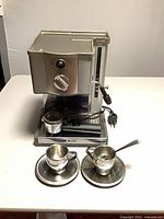 Front view showing Breville Café Roma machine with cups and saucers