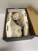 Sneakers inside original box showing overall wear and box included