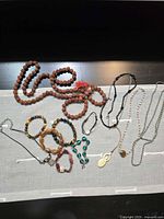 Full assortment of necklaces and bracelets laid out on cloth