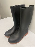 full side view of both boots showing black uppers and brown soles