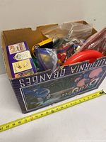 Box overview with mixed bricks and bags, tape measure showing width