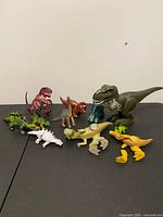 Group shot of all dinosaur figures on table