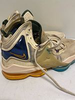 side view of both shoes showing mesh uppers, blue overlay, Air unit