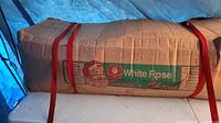 Cardboard box with White Rose Santa’s Choice branding and red straps