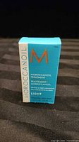 Front of boxed Moroccanoil Treatment Light