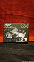 Retail box front showing War Lighter Mini Gun branding