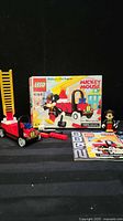 Boxed LEGO 4164 set with built fire engine, Mickey minifigure, instructions and extra pieces