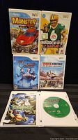 Five Wii game cases displayed, covers visible