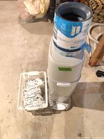 Front view of Diaper Genie pail with refill cartridge and basket