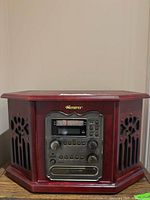 Front view showing Memorex logo, control panel with CD recorder, cassette slot, tuner scale, speaker grills