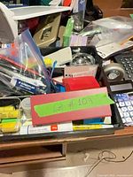 Tray of assorted pens, glue sticks, correction tape, sticky notes