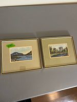 Both framed paintings side by side