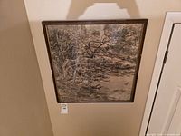 Full view of square framed artwork on wall