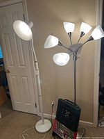 White gooseneck lamp, chrome five-head lamp, black Pack & Go rolling cart