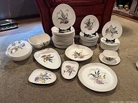 Full set of Gerbe porcelain plates, bowls and platters arranged on floor