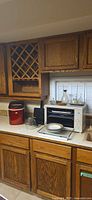 Igloo ice maker, waffle iron, toaster oven on countertop
