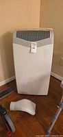 Front view of Kenmore portable air conditioner with vent adapter on floor