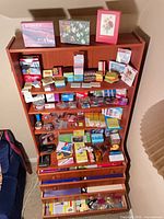 Full bookcase view showing variety of office supplies on multiple shelves