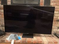 Front view of Samsung 55" QLED TV on stand