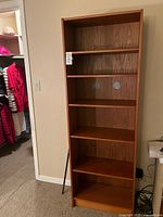 Front view of teak laminate bookshelf showing five shelves
