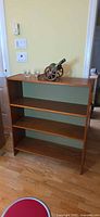 Front view of teak three-shelf bookcase