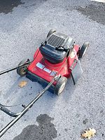 Full view of engine mounted on red mower deck