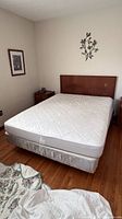 Queen bed with mattress, box spring, headboard, nightstand visible