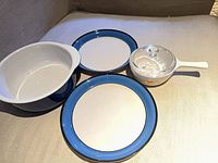 All four items: Corning Ware Wildflower saucepan with lid, blue Corelle bowl, two Nitto plates