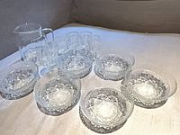 full set of pitcher, six glasses, six bowls displayed