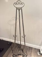 Full view of metal easel standing on floor