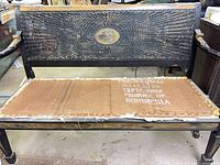 Full view of bench showing cane back and stripped seat