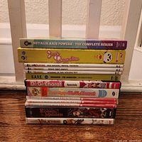Stack of anime DVD cases showing spines including Hetalia Axis Powers, Junjo Romantica, Ragnarok The Animation, Rozen Maiden, Valkyrie, Di Gi Charat