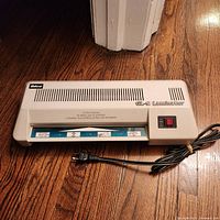 Front view of Ibico GL-9 laminator showing feed slot and power cord