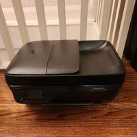 Closed printer front view showing compact design and lid
