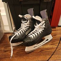Full view of both Bauer skates showing boots, laces, and blades