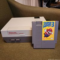 Front angled view of NES console and game cartridge